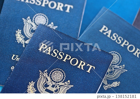 Many US passports on table close up. Official identification document books for citizens of United States. Concept of travel and tourism 138152181