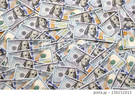 American dollars in one hundred banknotes. Lot of dollars close up. Stack of dollars and cash with a money background. US money and banknotes American dollars in one hundred banknotes. Lot of dollars close up. Stack of dollars and cash with a money background. US money and banknotes 138152813