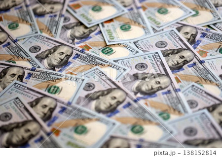 Stacks of hundred dollar bills showcase intricate designs on a flat surface. Money background with Franklin on the 100-dollar note Stacks of hundred dollar bills showcase intricate designs on a flat surface. Money background with Franklin on the 100-dollar note 138152814