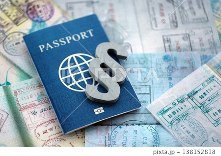 Paragraph symbol on passport pages full of colorful stamps after travel and tourism. Border control and lawsuit concept. Immigration and travel around the world Paragraph symbol on passport pages full of colorful stamps after travel and tourism. Border control and lawsuit concept. Immigration and travel around the world 138152818