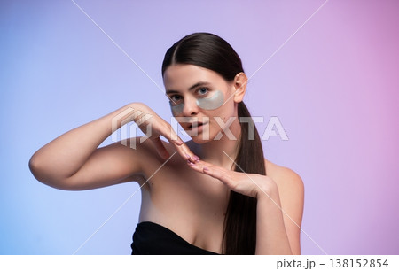 Young woman applying under eye patches for skin care routine, pampering facial treatment, self-care concept, beauty products, and anti-aging skincare Young woman applying under eye patches for skin care routine, pampering facial treatment, self-care concept, beauty products, and anti-aging skincare 138152854