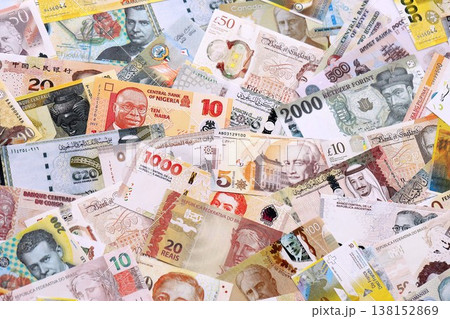 Various currencies money bills banknotes in yellow and orange color. Many cash bills from different countries in big pile close up. World economy and currency exchange concept Various currencies money bills banknotes in yellow and orange color. Many cash bills from different countries in big pile close up. World economy and currency exchange concept 138152869