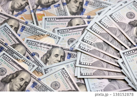 Stack of dollars and cash with a money background. US money and banknotes. Pile of 100 USD bills. American hundred-dollar notes. Pattern of money. Cash and credit theme 138152878