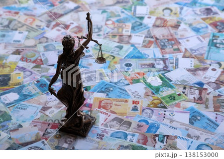 Themis figure against the background of pile of different currencies money bills. Concept of justice and corruption around the world Themis figure against the background of pile of different currencies money bills. Concept of justice and corruption around the world 138153000