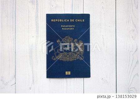Chile Republic passport lies on wooden table close up. Chilean blue new passport book in details Chile Republic passport lies on wooden table close up. Chilean blue new passport book in details 138153029