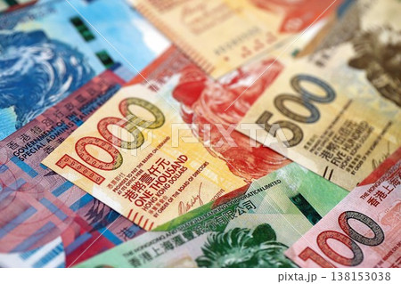 Big pile of Hong Kong dollars money bills banknotes close up. Lots of money of Chinese Hong Kong HKD currency cash in big bunch. Economics and business in HongKong 138153038