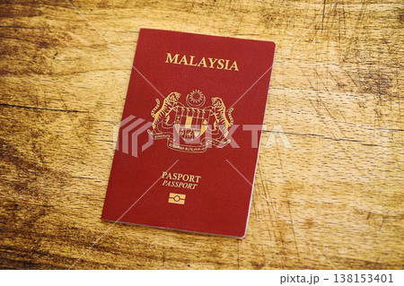 Malaysian passport on table close up. Official identification document book for citizens of Malaysia. Concept of travel and tourism 138153401