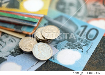 Australian dollar money bills and cent coins pile on table. Australia coins on banknotes of AUD currency close up. Concept of business, taxes and banking in Australia Australian dollar money bills and cent coins pile on table. Australia coins on banknotes of AUD currency close up. Concept of business, taxes and banking in Australia 138153428