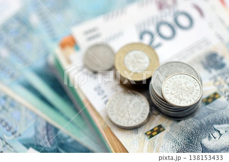 Polish zloty money bills and grosz coins pile on table. Poland coins on banknotes of PLN currency close up. Concept of business, taxes and banking in Poland 138153433