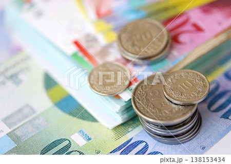 Swiss franc money bills and cent coins pile on table. Switzerland coins on banknotes of CHF currency close up. Concept of business, taxes and banking in Switzerland 138153434
