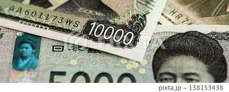 Japanese yen money bills pile on table. Japan banknotes of JPY currency close up. Concept of business, economy and banking in Japan 138153438