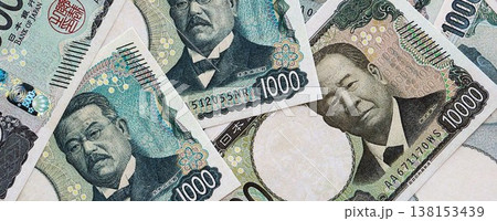 Japanese yen money bills pile on table. Japan banknotes of JPY currency close up. Concept of business, economy and banking in Japan 138153439