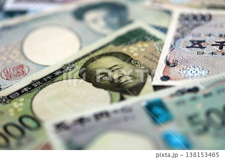 Japanese yen money bills pile on table. Japan banknotes of JPY currency close up. Concept of business, economy and banking in Japan 138153465