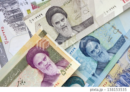 Iranian rial money bills pile on table. Iran banknotes of IRR currency close up. Concept of business, economy and banking in Iran Iranian rial money bills pile on table. Iran banknotes of IRR currency close up. Concept of business, economy and banking in Iran 138153535