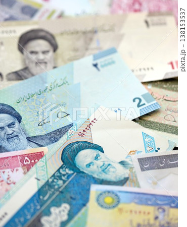 Iranian rial money bills pile on table. Iran banknotes of IRR currency close up. Concept of business, economy and banking in Iran Iranian rial money bills pile on table. Iran banknotes of IRR currency close up. Concept of business, economy and banking in Iran 138153537