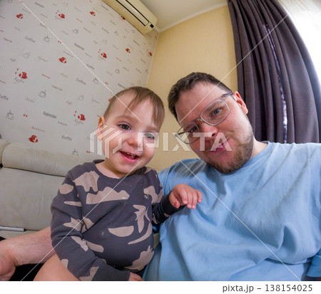 Smiling father and toddler taking a wide-angle selfie at home 138154025