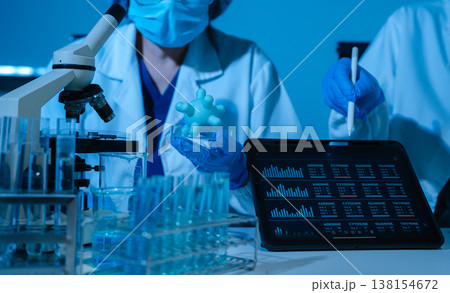 Healthcare professional holding Coronavirus COVID-19 vaccine in laboratory study and analyze scientific sample of Coronavirus antibody. Healthcare professional holding Coronavirus COVID-19 vaccine in laboratory study and analyze scientific sample of Coronavirus antibody. 138154672