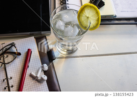 Remote worker productivity concept featuring a casual work environment with essential tools and a refreshing drink 138155423