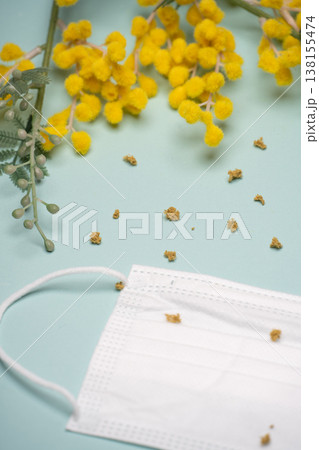 ミモザの花粉が落ちた白いマスクの接写 ミモザの花粉が落ちた白いマスクの接写 138155474