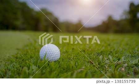 Golf ball is on a green lawn in a beautiful golf course with morning sunshine. Golf ball is on a green lawn in a beautiful golf course with morning sunshine. 138155739