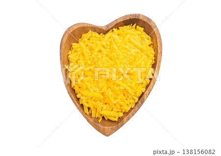 Bowl of shredded cheddar cheese isolated on white background closeup texture of grated dairy ingredient for cooking and recipes 138156082