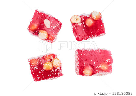 Turkish delight lokum cubes with hazelnuts and almonds coated in coconut flakes. Sweet jelly candy isolated on white background.. Turkish delight lokum cubes with hazelnuts and almonds coated in coconut flakes. Sweet jelly candy isolated on white background.. 138156085