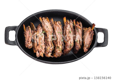 Sliced roasted lamb breast ribs in cast iron pan on isolated background barbecue meat with copy space. Sliced roasted lamb breast ribs in cast iron pan on isolated background barbecue meat with copy space. 138156140