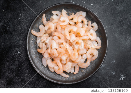 Mini salad shrimp in ceramic plate on dark stone surface, healthy seafood protein concept with space for text. Mini salad shrimp in ceramic plate on dark stone surface, healthy seafood protein concept with space for text. 138156169