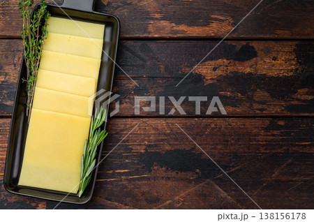 Stack of semi hard yellow cheese slices arranged on black tray, dairy ingredient on vintage wooden table background Stack of semi hard yellow cheese slices arranged on black tray, dairy ingredient on vintage wooden table background 138156178