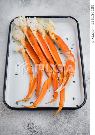 Cooked red king crab legs on white tray with lemon and thyme light stone background premium seafood with copy space Cooked red king crab legs on white tray with lemon and thyme light stone background premium seafood with copy space 138156189