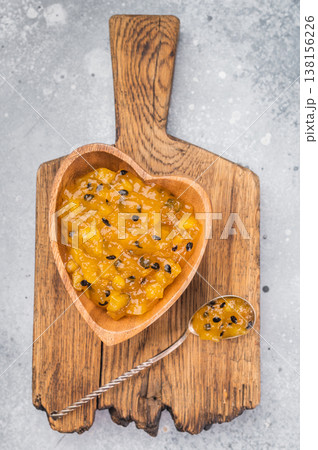Romantic food concept with mango maracuja preserve served in heart bowl, exotic fruit dessert topping close up Romantic food concept with mango maracuja preserve served in heart bowl, exotic fruit dessert topping close up 138156226