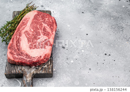 Premium raw beef ribeye entrecote steak with visible fat marbling. Natural fresh meat cut on rustic background with copy space. Premium raw beef ribeye entrecote steak with visible fat marbling. Natural fresh meat cut on rustic background with copy space. 138156244