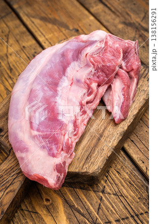Raw lamb meat breast with herbs and garlic on rustic wooden table fatty cut ingredient for bbq roasting and braising 138156291