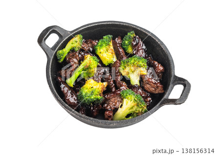 Beef and broccoli stir fry cooked in wok style sauce served in small skillet on isolated background 138156314