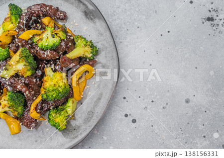 Beef stir fry with broccoli and bell pepper in savory sauce served on plate on white background Beef stir fry with broccoli and bell pepper in savory sauce served on plate on white background 138156331