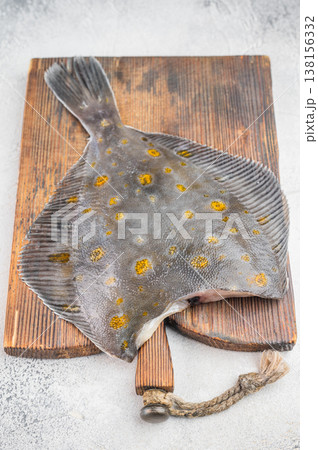Raw fluke flatfish seafood on wooden board with thyme and pepper fresh marine fish ingredient Raw fluke flatfish seafood on wooden board with thyme and pepper fresh marine fish ingredient 138156332