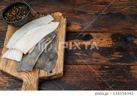 Fresh plaice flatfish fillets on wooden board with spices raw seafood ingredient on rustic background 138156342