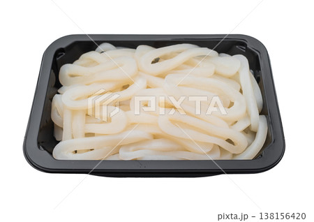 Fresh sliced calamari rings in a black plastic tray on a light grey background ideal seafood ingredient for healthy cooking. 138156420