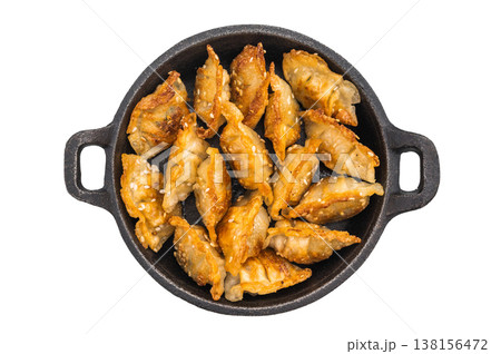 Crispy dim sum gyoza with sesame on dark plate against bright background. Asian fried dumplings ideal for culinary blogs and restaurant promotions. 138156472