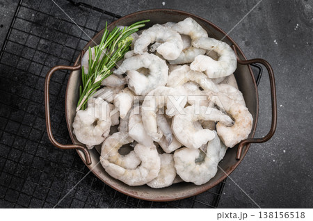 Frozen raw shrimp prawns in a rustic metal bowl with fresh rosemary. Dark and moody food photography for a premium gourmet menu. Frozen raw shrimp prawns in a rustic metal bowl with fresh rosemary. Dark and moody food photography for a premium gourmet menu. 138156518