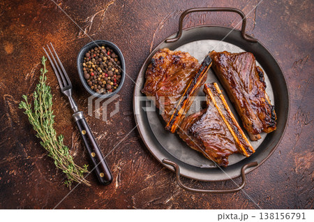 Rustic Short Ribs: Rich, glazed beef ribs in a dark and moody style, perfect for high-end restaurant advertising and menus. 138156791