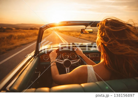 Woman driving convertible car on sunset road travel freedom lifestyle concept Woman driving convertible car on sunset road travel freedom lifestyle concept 138156897