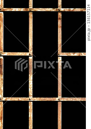 Rusty metal grid pattern against a black background Rusty metal grid pattern against a black background 138157114