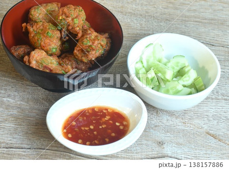 fried grouper fish patty with slice cucumber on bowl dipping sweet chili sauce fried grouper fish patty with slice cucumber on bowl dipping sweet chili sauce 138157886