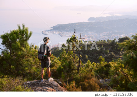 Summer landscape with tourist on the edge of the mountains Summer landscape with tourist on the edge of the mountains 138158336