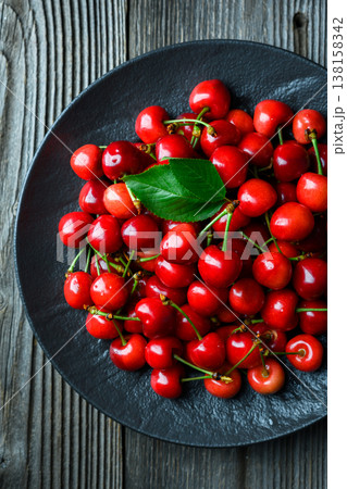 Top view of cherries arranged in black plate Top view of cherries arranged in black plate 138158342