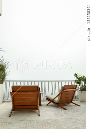 Chairs placed on a balcony with a view of the sky Chairs placed on a balcony with a view of the sky 138158394