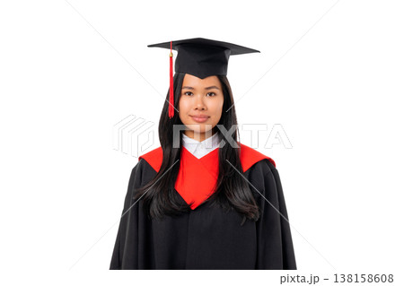 A woman stands smiling in her graduation cap and gown, isolated, PNG A woman stands smiling in her graduation cap and gown, isolated, PNG 138158608