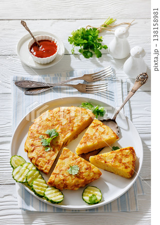 spanish potato omelette, tortilla on a plate spanish potato omelette, tortilla on a plate 138158981