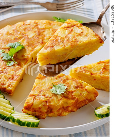spanish potato omelette, tortilla on a plate spanish potato omelette, tortilla on a plate 138158986